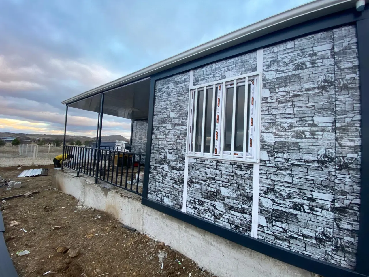 56 m² Modüler Ev: taş desenli duvar ve pencere